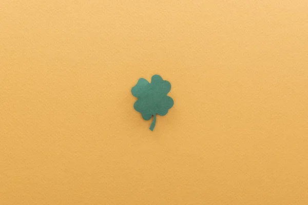 Top view of shamrock isolated on orange with copy space, st patrick day concept — Stock Photo