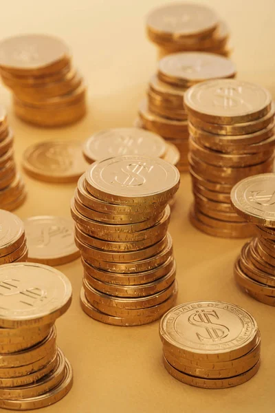 Selective focus of golden coins with dollar signs isolated on orange, st patrick day concept — Stock Photo