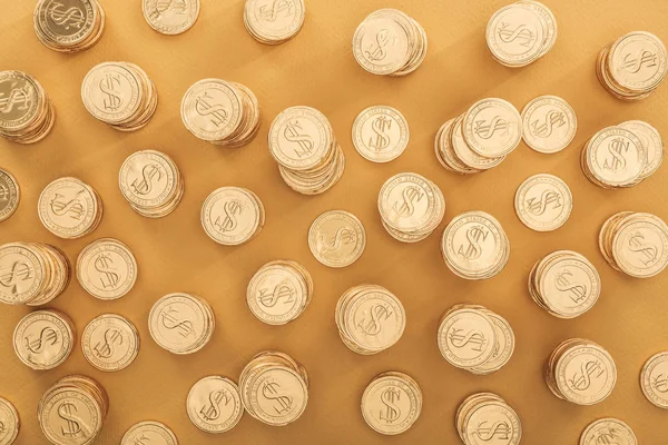 Top view of golden coins with dollar signs isolated on orange, st patrick day concept — Stock Photo