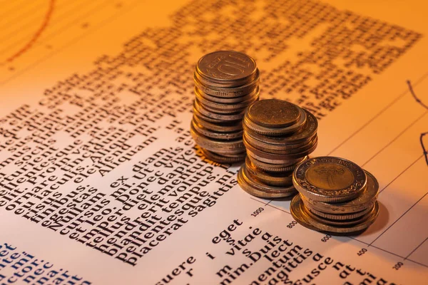 Selective focus of coins stacks on business text document — Stock Photo