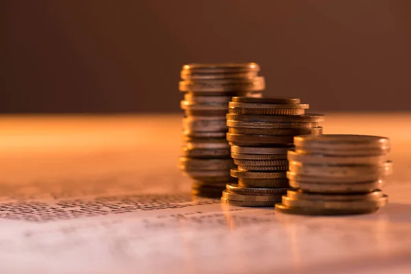 Selective focus of coins stacks on text document and blurred background — Stock Photo