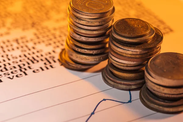 Selective focus of coins stacks on business document with graphs — Stock Photo