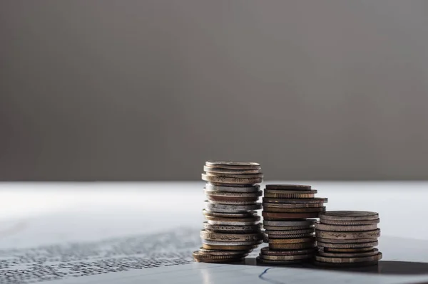 Selective focus of coins stacks on document and blurred grey background — Stock Photo