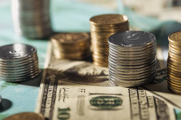 Selective focus of ukrainian coins stacks on dollar banknotes with blurred background — Stock Photo