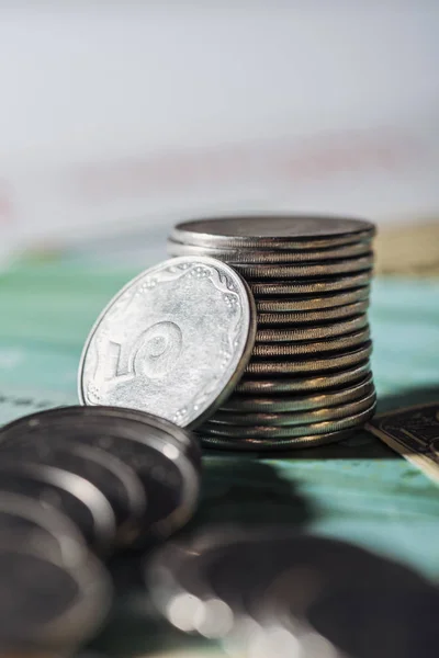 Selective focus of scattered ukrainian coins stack on green background — Stock Photo