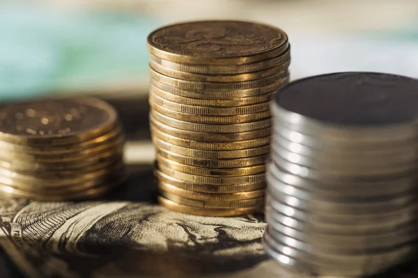 Selective focus of ukrainian coins stacks on dollar banknote with blurred background — Stock Photo