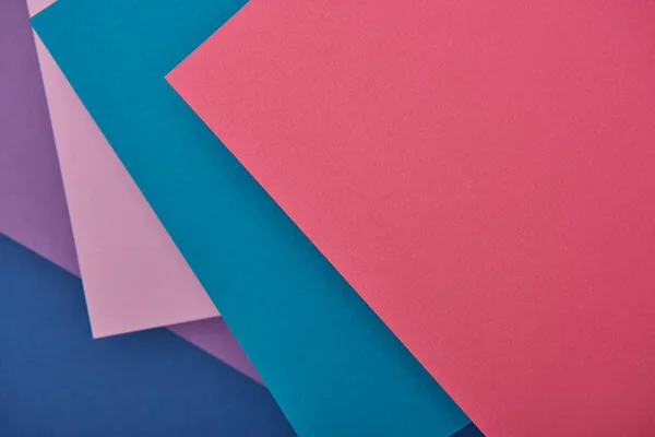 Top view of lilac, blue and pink paper sheets with copy space — Stock Photo