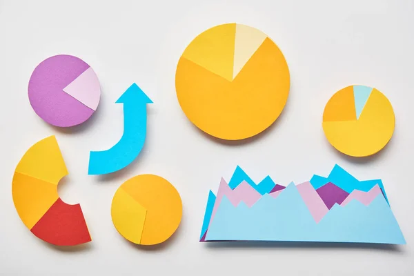 Top view of charts and graphs, pointer made of paper on white background — Stock Photo