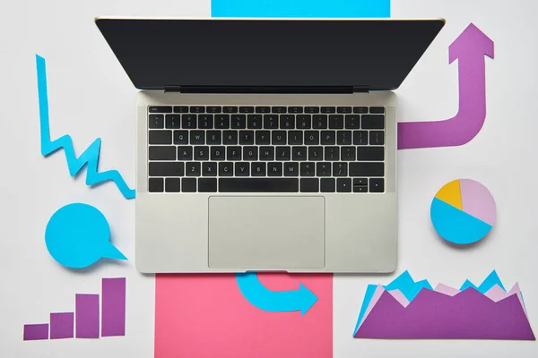 Top view of paper charts and graphs, pointers, sheet of paper, opened laptop on white background — Stock Photo