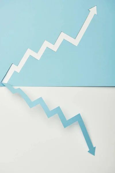 Top view of symmetric situating paper pointers on white and blue background — Stock Photo