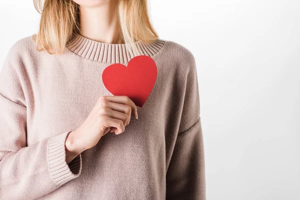 Cropped view of woman in beige sweater holding paper heart — Stock Photo