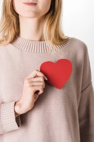 Cropped view of blonde woman in beige sweater holding paper heart — Stock Photo