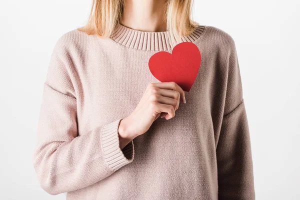 Partial view of blonde woman in beige sweater holding paper heart — Stock Photo