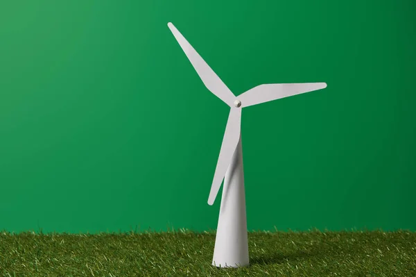 White windmill model on green grass and background — Stock Photo