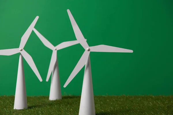 Windmill models on grass and green background — Stock Photo