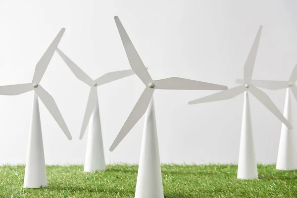 Modelos de molino de viento sobre hierba y fondo blanco - foto de stock