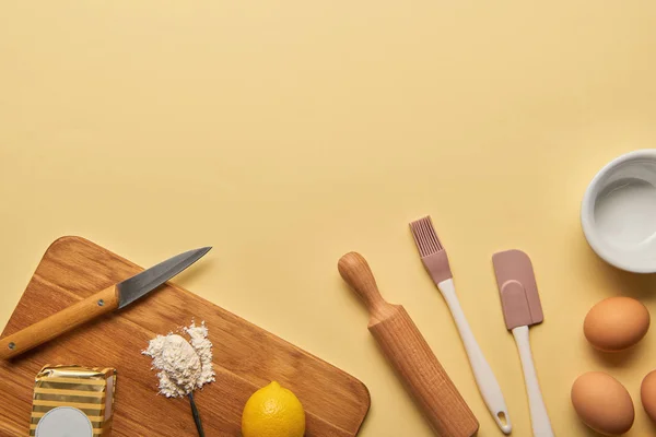 Top view of cooking utensils and ingredients on yellow background with copy space — Stock Photo