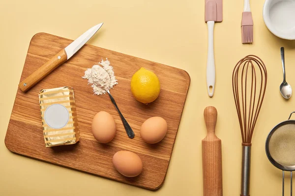 Top view of cooking utensils and ingredients on yellow background — Stock Photo