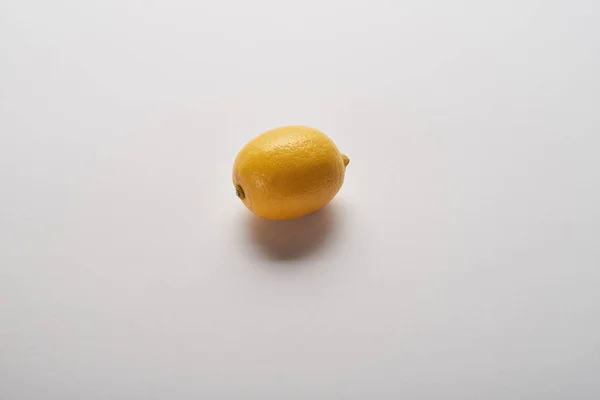 Yellow ripe whole lemon on grey background — Stock Photo