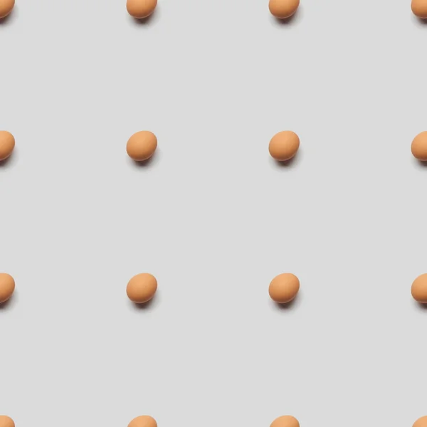 Organic brown eggs on grey background, seamless pattern — Stock Photo