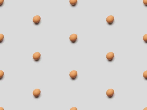 Organic brown eggs on grey background, seamless pattern — Stock Photo