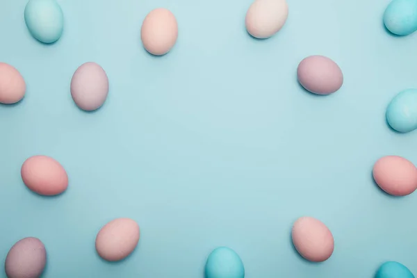 Top view of easter eggs on blue background with copy space — Stock Photo