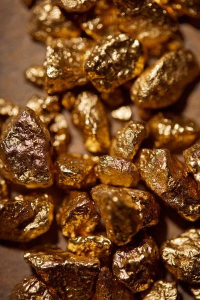 Top view of golden stones on brown background — Stock Photo