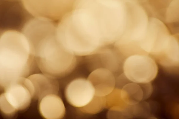 Bright brown background with golden sparkling lights — Stock Photo