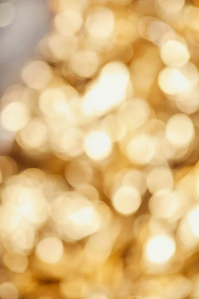 Bright blurred golden twinkles and sparkles on grey background — Stock Photo