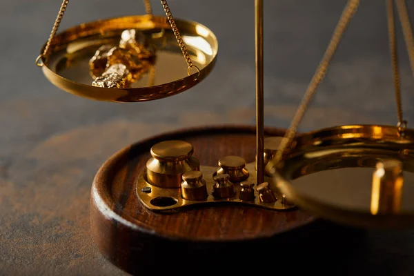 Vintage scales with golden stones on textured marble background — Stock Photo