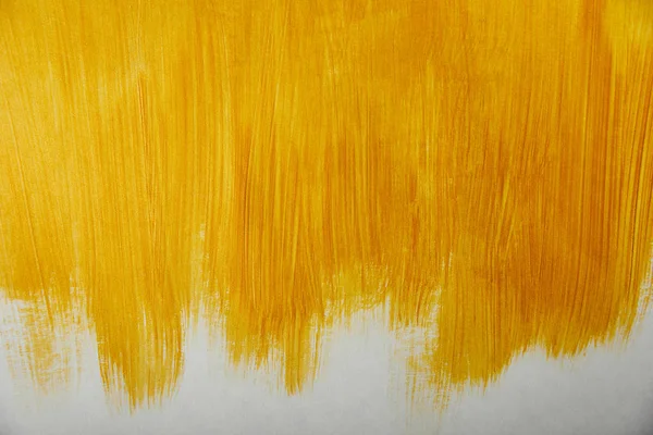 Golden brushstrokes drawn on white background — Stock Photo