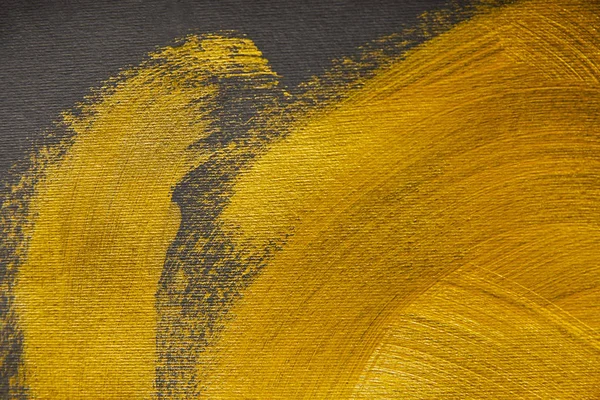 Golden brushstrokes drawn on grey textured background — Stock Photo