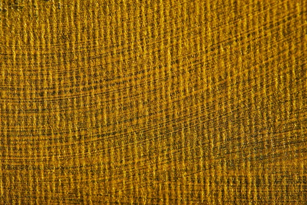 Серый холст, нарисованный мазками кисти с золотой краской — стоковое фото