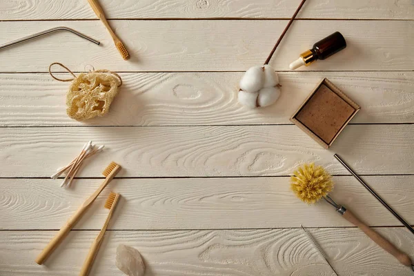 Top view of various hygiene and care items on white wooden surface, zero waste concept — Stock Photo