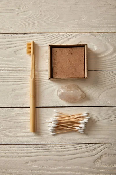 Top view of different hygiene and care items on white wooden surface, zero waste concept — Stock Photo