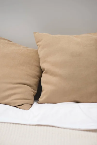 Close up of brown pillows on cozy bed — Stock Photo