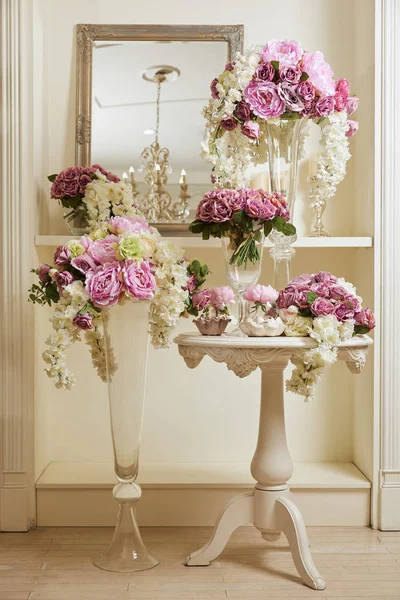 Interior do quarto com espelho e flores em vasos de vidro — Fotografia de Stock