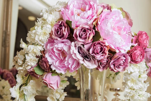 Gros plan de fleurs blanches et violettes dans un vase en verre — Photo de stock