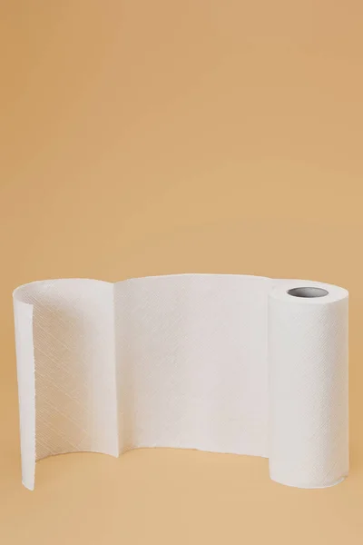 Roll of paper napkin on beige background — Stock Photo