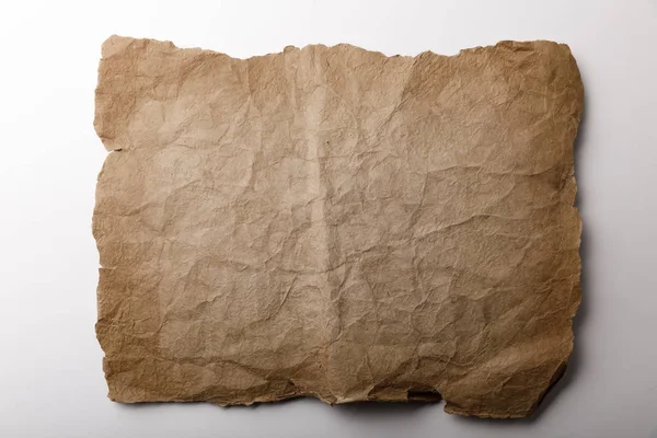 Vue de dessus de la vieille feuille de papier couchée sur fond blanc — Photo de stock