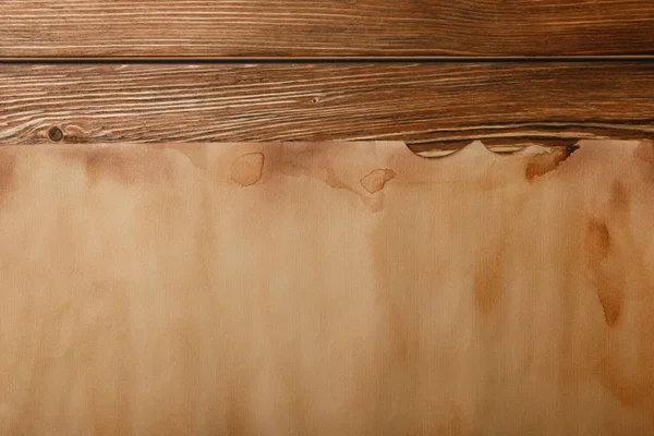 Top view of antique parchment paper lying on wooden background — Stock Photo