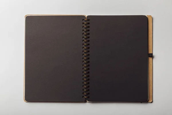 Top view of black opened notebook on white background — Stock Photo