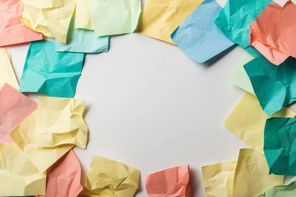 Top view of crumpled colorful sticky notes on white background — Stock Photo