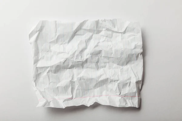 Top view of white lined crumpled page on white background — Stock Photo