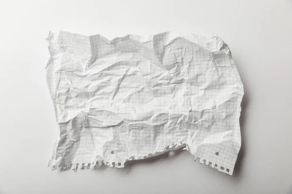 Top view of blank squared crumpled page on white background — Stock Photo
