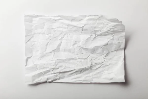 Top view of blank crumpled page on white background — Stock Photo