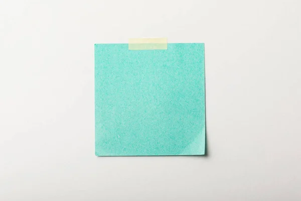 Turquoise blank sticker with sticky tape on white background — Stock Photo