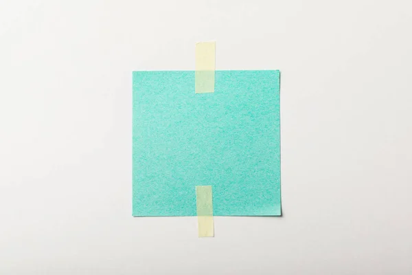 Turquoise blank paper with sticky tape on white background — Stock Photo