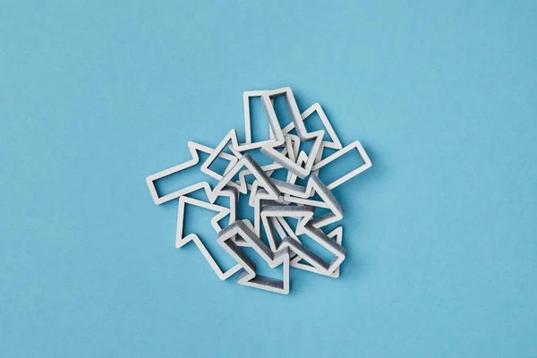 Top view of mixed white arrows on blue background — Stock Photo