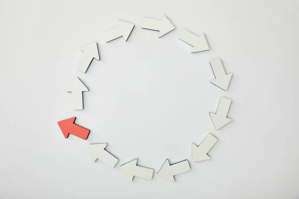 Top view of circle with white pointers and red arrow on grey background — Stock Photo